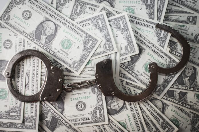 crime-dolar-laranja Dólares com uma algema de crimes